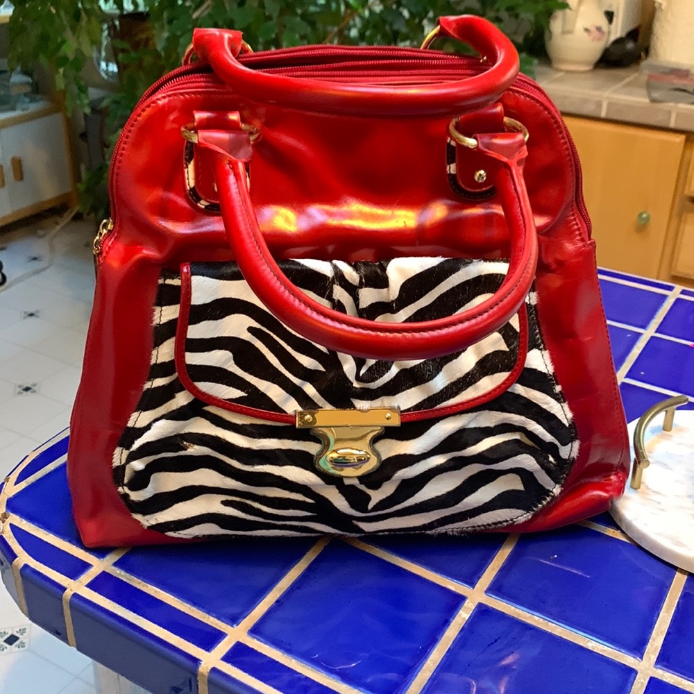 The Find Cherry Red leather bag with Zebra cowhide pocket in front.